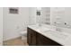Bathroom with double sink vanity, white quartz counters, and modern fixtures at 16081 W Remuda Dr, Surprise, AZ 85387