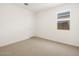 Bright, spacious bedroom with carpet, and a window allowing natural light at 16081 W Remuda Dr, Surprise, AZ 85387