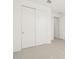 Bedroom featuring neutral carpet, white trim, and a closet with sliding doors at 16081 W Remuda Dr, Surprise, AZ 85387