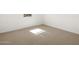 This bedroom features neutral carpet, white walls and trim, and a window at 16081 W Remuda Dr, Surprise, AZ 85387