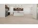 Bright living space with wood-look floors connects to a kitchen island and dining area at 16081 W Remuda Dr, Surprise, AZ 85387