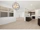 Open-concept living space boasts sleek wood-look tile flooring and contemporary lighting fixtures at 16081 W Remuda Dr, Surprise, AZ 85387