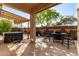 Outdoor patio featuring a hot tub, pergola, and dining set perfect for relaxation and entertaining at 17696 N 168Th Dr, Surprise, AZ 85374