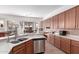 Spacious kitchen featuring stainless steel dishwasher, long countertops, and wood cabinets at 17696 N 168Th Dr, Surprise, AZ 85374