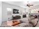 Cozy living room features a fireplace and ceiling fan at 17696 N 168Th Dr, Surprise, AZ 85374