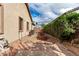 Side yard with raised garden beds, a brick pathway, and privacy landscaping at 17696 N 168Th Dr, Surprise, AZ 85374