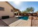 Backyard showcasing a private pool with a covered patio, ideal for outdoor relaxation at 17696 N 168Th Dr, Surprise, AZ 85374