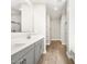 Bathroom features double sinks, modern cabinetry, walk-in shower and tile flooring at 17809 W Elm St, Goodyear, AZ 85395
