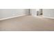 Bright bedroom features neutral carpeting, baseboards and fresh paint at 17809 W Elm St, Goodyear, AZ 85395