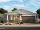 Charming single-story home with a stone-accented facade, a two-car garage, and desert landscaping at 17809 W Elm St, Goodyear, AZ 85395