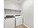 Laundry room with newer washer and dryer and storage shelf at 17809 W Elm St, Goodyear, AZ 85395