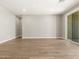 Open concept living room with neutral walls, tile flooring, and sliding glass door at 17809 W Elm St, Goodyear, AZ 85395