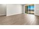 Light-filled living room with tile flooring, neutral walls, and glass sliding door at 17809 W Elm St, Goodyear, AZ 85395