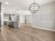 Spacious living space with wood-look flooring, and modern lighting at 17809 W Elm St, Goodyear, AZ 85395