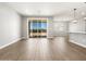 Open living space with sliding door to backyard, wood-look tile, and modern lighting at 17809 W Elm St, Goodyear, AZ 85395
