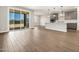 Light-filled living space with wood-look tile, opens to the kitchen at 17809 W Elm St, Goodyear, AZ 85395