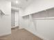 Walk-in closet featuring open shelving for organization and storage at 17809 W Elm St, Goodyear, AZ 85395