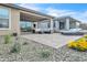 Expansive backyard with desert landscaping, paved patio, outdoor seating, and views of neighboring houses at 18332 E Spring Valley Ct, Rio Verde, AZ 85263