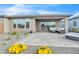 Beautiful backyard boasts desert landscaping, vibrant flowers, and a spacious brick patio at 18332 E Spring Valley Ct, Rio Verde, AZ 85263
