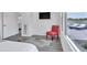 Bright bedroom featuring a red accent chair and view to an outdoor patio with lounge chairs at 18332 E Spring Valley Ct, Rio Verde, AZ 85263