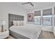 A cozy bedroom with gray hues, a large window, and a decorative print at 18332 E Spring Valley Ct, Rio Verde, AZ 85263