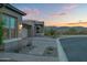 Desert home exterior with brick paver driveway and lush desert landscaping at 18332 E Spring Valley Ct, Rio Verde, AZ 85263