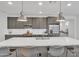 Spacious kitchen island with quartz countertops, pendant lighting and stainless steel appliances at 18332 E Spring Valley Ct, Rio Verde, AZ 85263