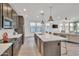Bright, open kitchen flows to living area, with island, stainless appliances, and modern cabinetry at 18332 E Spring Valley Ct, Rio Verde, AZ 85263