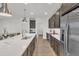 A modern, open-concept kitchen featuring a large island, stainless steel appliances, and sleek countertops at 18332 E Spring Valley Ct, Rio Verde, AZ 85263