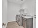 A practical laundry room with front-load washer and dryer, shelving, and storage at 18332 E Spring Valley Ct, Rio Verde, AZ 85263