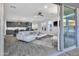 Open-concept living space features tile floors, modern furnishings, and a seamless transition to the outdoors at 18332 E Spring Valley Ct, Rio Verde, AZ 85263