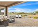Relaxing outdoor patio features stylish seating, lounge chairs, and views of the surrounding desert landscape at 18332 E Spring Valley Ct, Rio Verde, AZ 85263