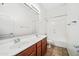Bathroom featuring a double sink vanity and a shower-tub combo at 19245 W Pasadena Ave, Litchfield Park, AZ 85340