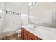 Bright bathroom featuring a single sink vanity and a shower-tub combo at 19245 W Pasadena Ave, Litchfield Park, AZ 85340