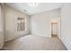 Bright bedroom with neutral carpet and large window, walk-in closet at 19245 W Pasadena Ave, Litchfield Park, AZ 85340