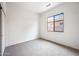 Cozy carpeted bedroom with a large window providing natural light at 19245 W Pasadena Ave, Litchfield Park, AZ 85340