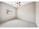 Carpeted bedroom with ceiling fan and natural light streaming through the window at 19245 W Pasadena Ave, Litchfield Park, AZ 85340