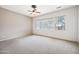 Spacious bedroom features a ceiling fan and multiple windows offering lots of light at 19245 W Pasadena Ave, Litchfield Park, AZ 85340