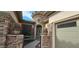 Close up of front door with gated entry and decorative cactus planters at 19245 W Pasadena Ave, Litchfield Park, AZ 85340