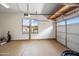 Spacious two car garage with epoxy flooring, large windows, and automatic door opener for convenience at 19245 W Pasadena Ave, Litchfield Park, AZ 85340