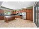Well-lit kitchen with stainless steel appliances, dark countertops, and ample cabinet space, designed for functionality and style at 19245 W Pasadena Ave, Litchfield Park, AZ 85340