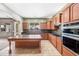 Spacious kitchen featuring an island, stainless steel appliances, and tiled floors at 19245 W Pasadena Ave, Litchfield Park, AZ 85340