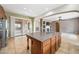 The kitchen island opens to living room and access to the outdoor patio at 19245 W Pasadena Ave, Litchfield Park, AZ 85340