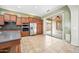 The kitchen features stainless steel appliances, wooden cabinets, and access to the outdoor patio at 19245 W Pasadena Ave, Litchfield Park, AZ 85340