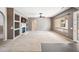 Open living room featuring a fireplace and large window for natural light at 19245 W Pasadena Ave, Litchfield Park, AZ 85340