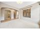 Bright living room with archways and neutral tones and carpet at 19245 W Pasadena Ave, Litchfield Park, AZ 85340