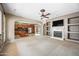 Bright living area flows into a stylish kitchen with built-in shelving and a fireplace, creating a welcoming atmosphere at 19245 W Pasadena Ave, Litchfield Park, AZ 85340