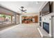 Open-concept living space with a fireplace, seamlessly connecting to a modern kitchen, ideal for Gathering gatherings at 19245 W Pasadena Ave, Litchfield Park, AZ 85340
