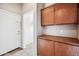 Mud room with built in cabinets, tile floor, and access to the garage at 19245 W Pasadena Ave, Litchfield Park, AZ 85340