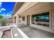 Covered patio with concrete floor and large window overlooking landscaped backyard, perfect for outdoor living at 19245 W Pasadena Ave, Litchfield Park, AZ 85340